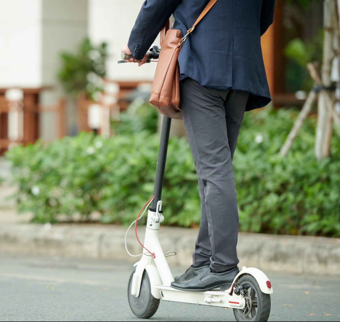Entrepreneur Riding on Electric Scooter